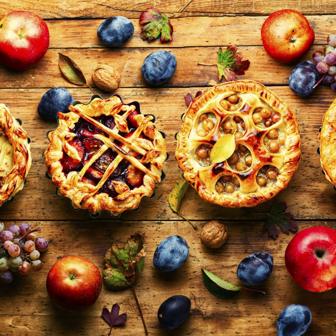 Assortment of autumn fruit pie or tartlet.Pie baked of apples,pears,grapes and plums.Top view