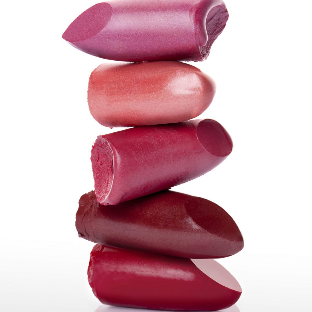 Cut and stacked lipsticks on white background